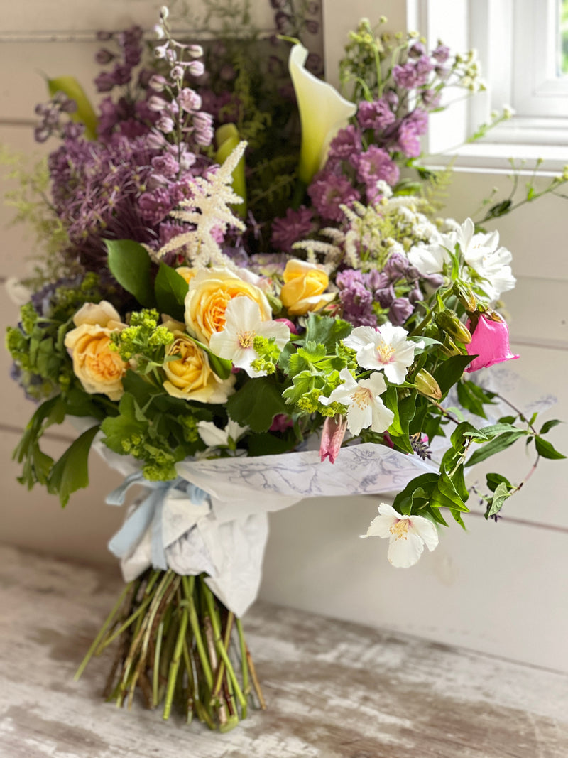 blooming plants, pink, yellow, violet, wrapped flower bouquet, green heart succulent