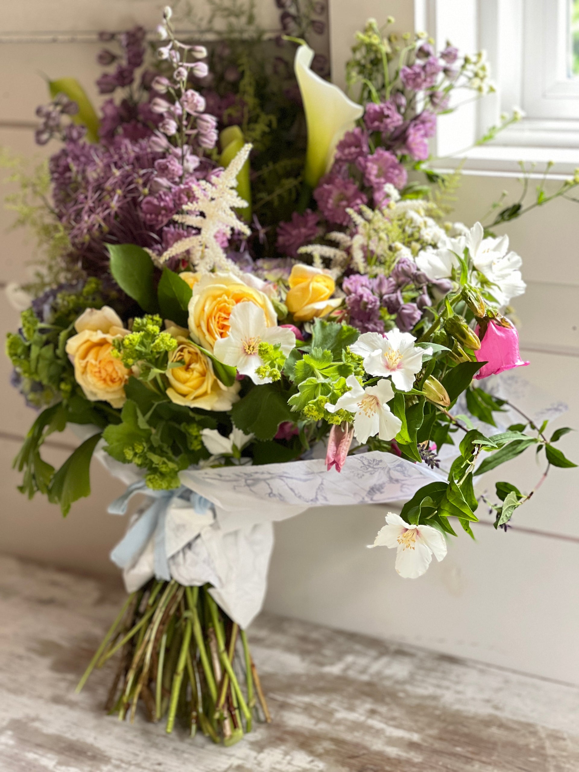 blooming plants, pink, yellow, violet, wrapped flower bouquet, green heart succulent