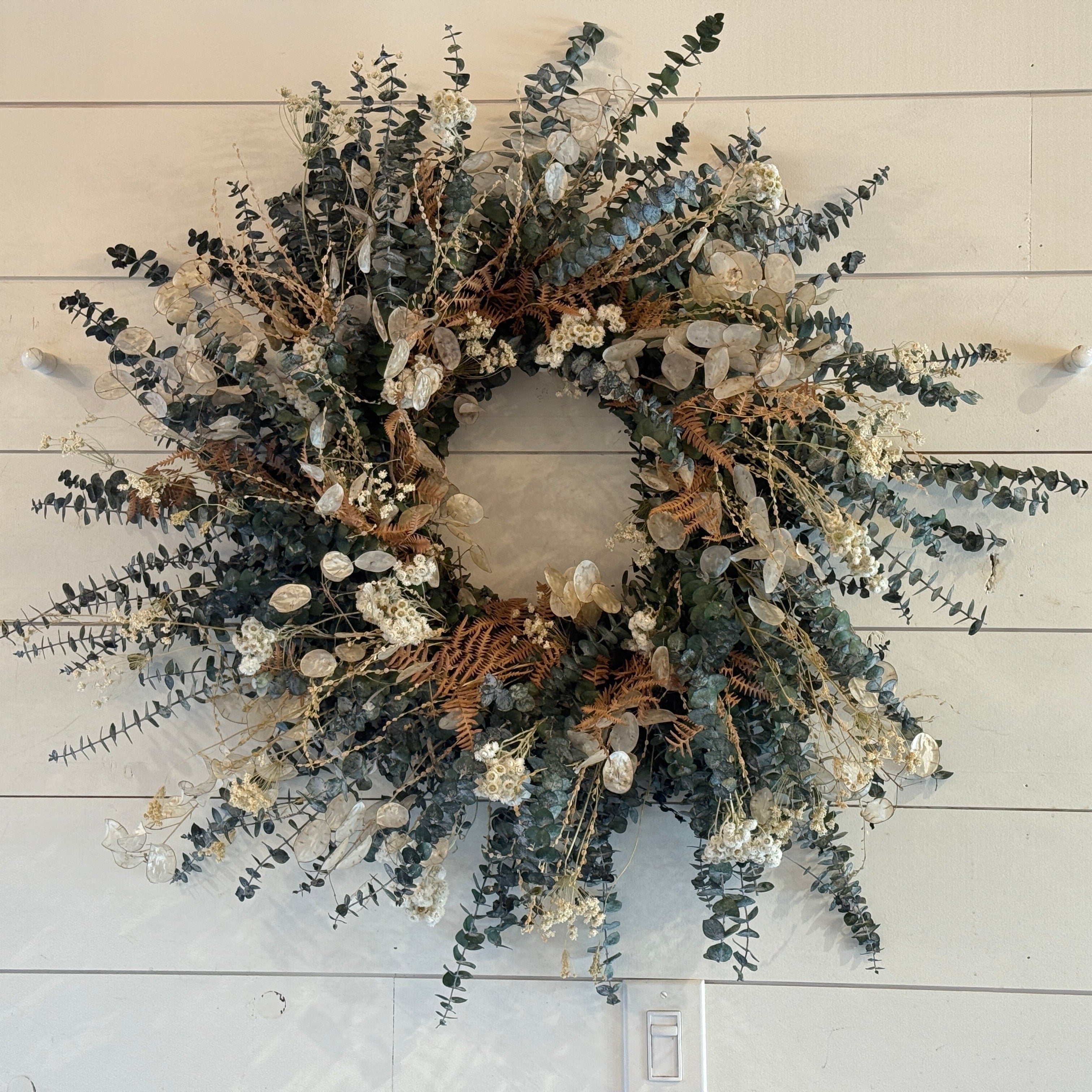 handmade wreath of eucalyptus and dried flowers and foliage