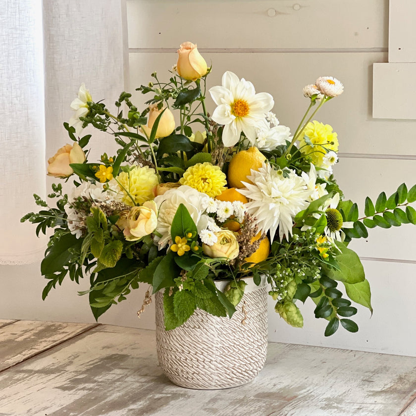 bright mixture of flowers and textures in ceramic vase