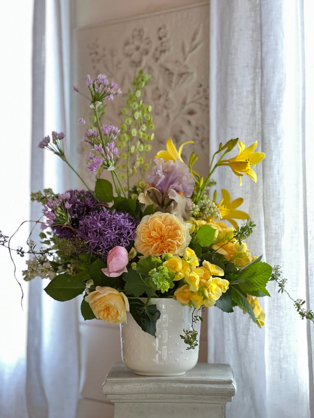 bright mixture of spring flowers in ceramic vase