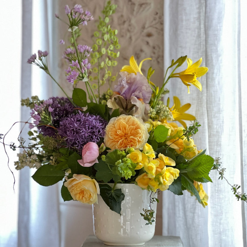 bright mixture of spring flowers in ceramic vase